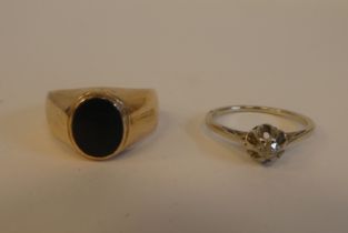 A gold coloured metal signet ring, set with an oval black stone; and a gold coloured metal claw