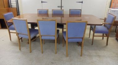 Attributed to Gordon Russell, a rosewood draw leaf dining table, the oval top raised on parallel