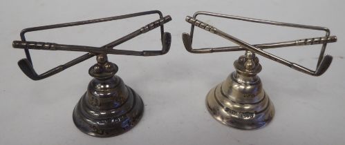 A pair of Edwardian loaded silver novelty golfing trophy menu holders, fashioned as crossed golf