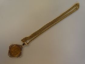 A yellow metal French 20F 1910 coin, in a decoratively scrolled pendant frame, on a chiselled