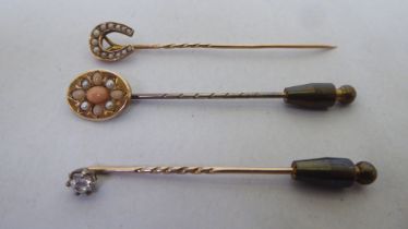 Three dissimilar antique, variously set stick pins
