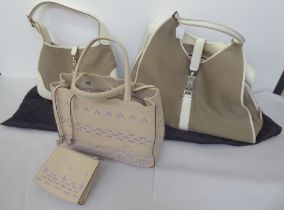 A Gucci holdall and matching handbag in fawn and cream canvas with dust cover; and a Anya