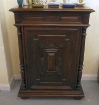 A late 19thC Continental oak cabinet with a drawer and panelled door, raised on bun feet  43"h  32"w