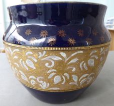 An early 20thC Royal Doulton stoneware jardinière with impressed lace banded decoration  bears