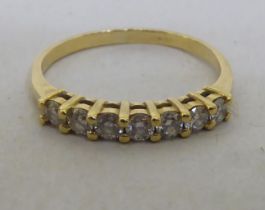 An 18ct gold claw set, seven stone diamond ring