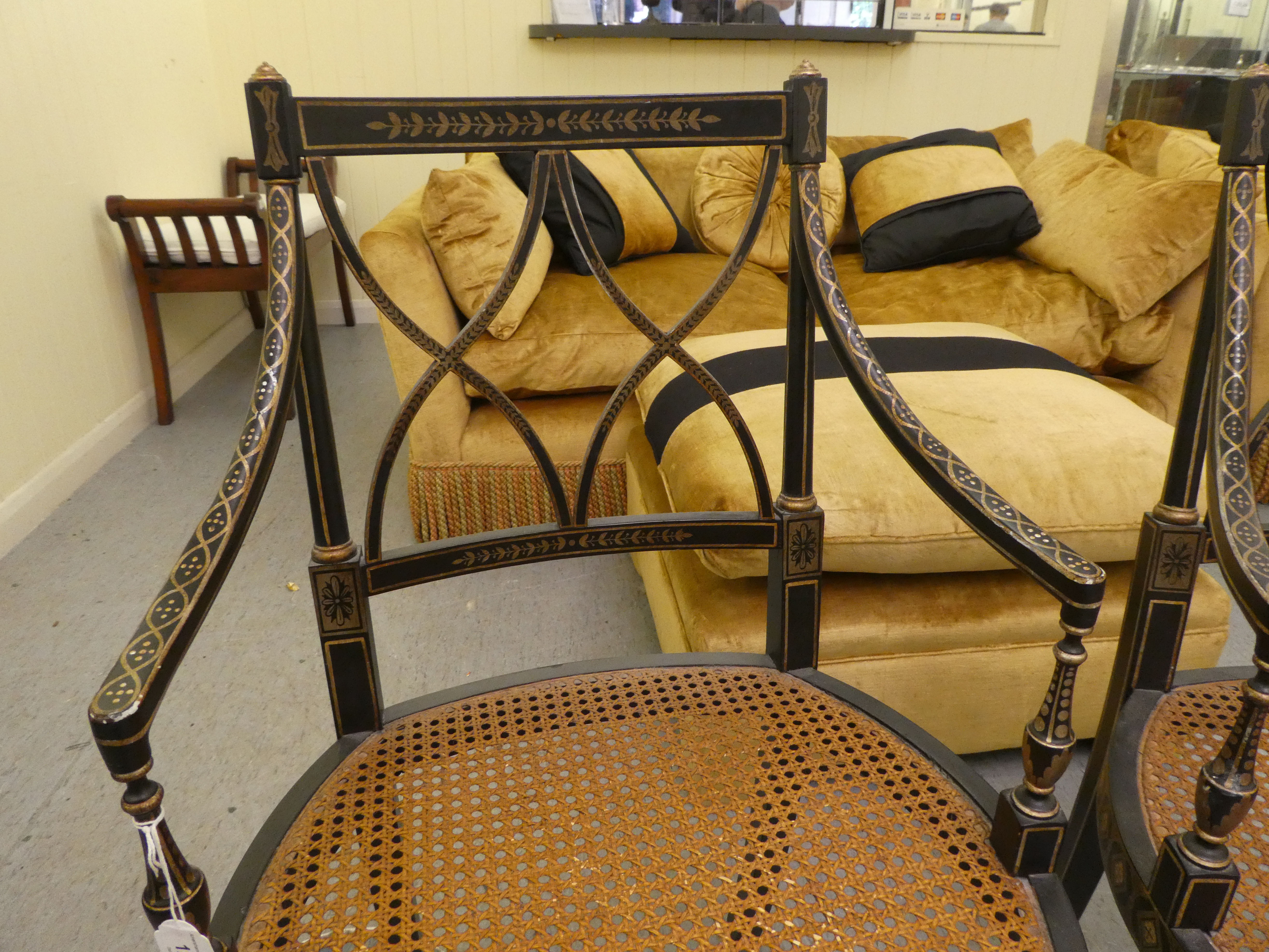A pair of early 19thC style black painted and gilded beech framed chairs, each having a curved - Image 4 of 6