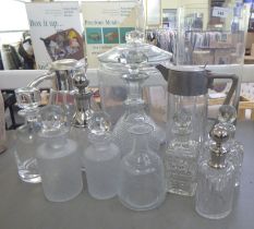 Glass tableware: to include two cordial jugs with applied metal mounts