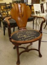 An Edwardian style mahogany and marquetry elbow chair with a solid back and open arms, the