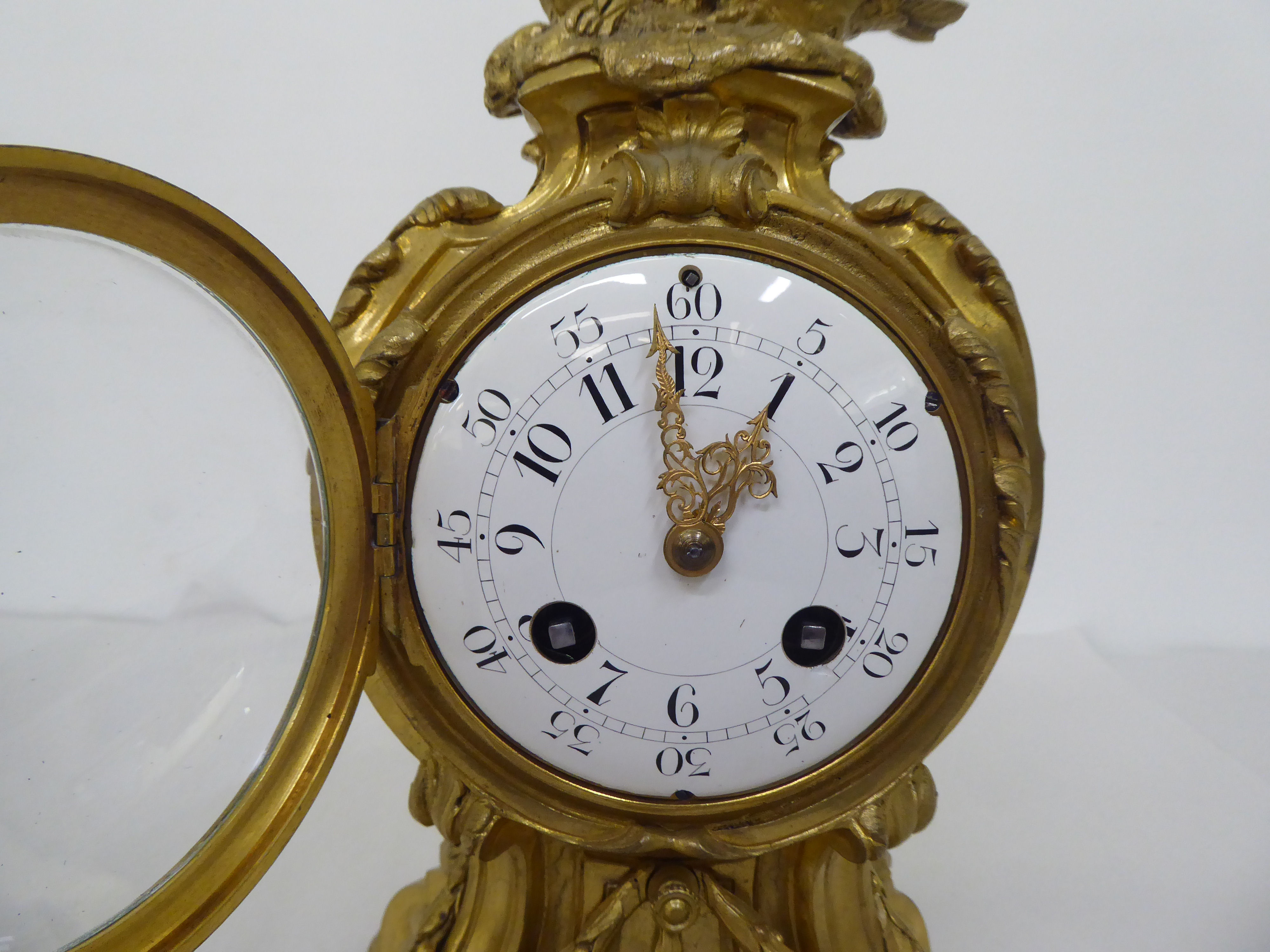 A reproduction of a 19thC gilt metal cased mantel clock of balloon design, surmounted by a pair of - Image 2 of 8