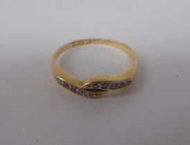 An 18ct gold diamond set crossover ring