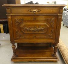 A late 19thC Continental oak cabinet with a drawer and a carved panelled door, raised on turned legs