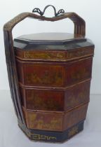 A modern Chinese black lacquered and gilded octagonal four part food carrier  26"h