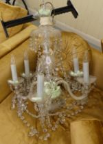 A 20thC copy of an earlier French clear glass chandelier with five scrolled branches, pendants and