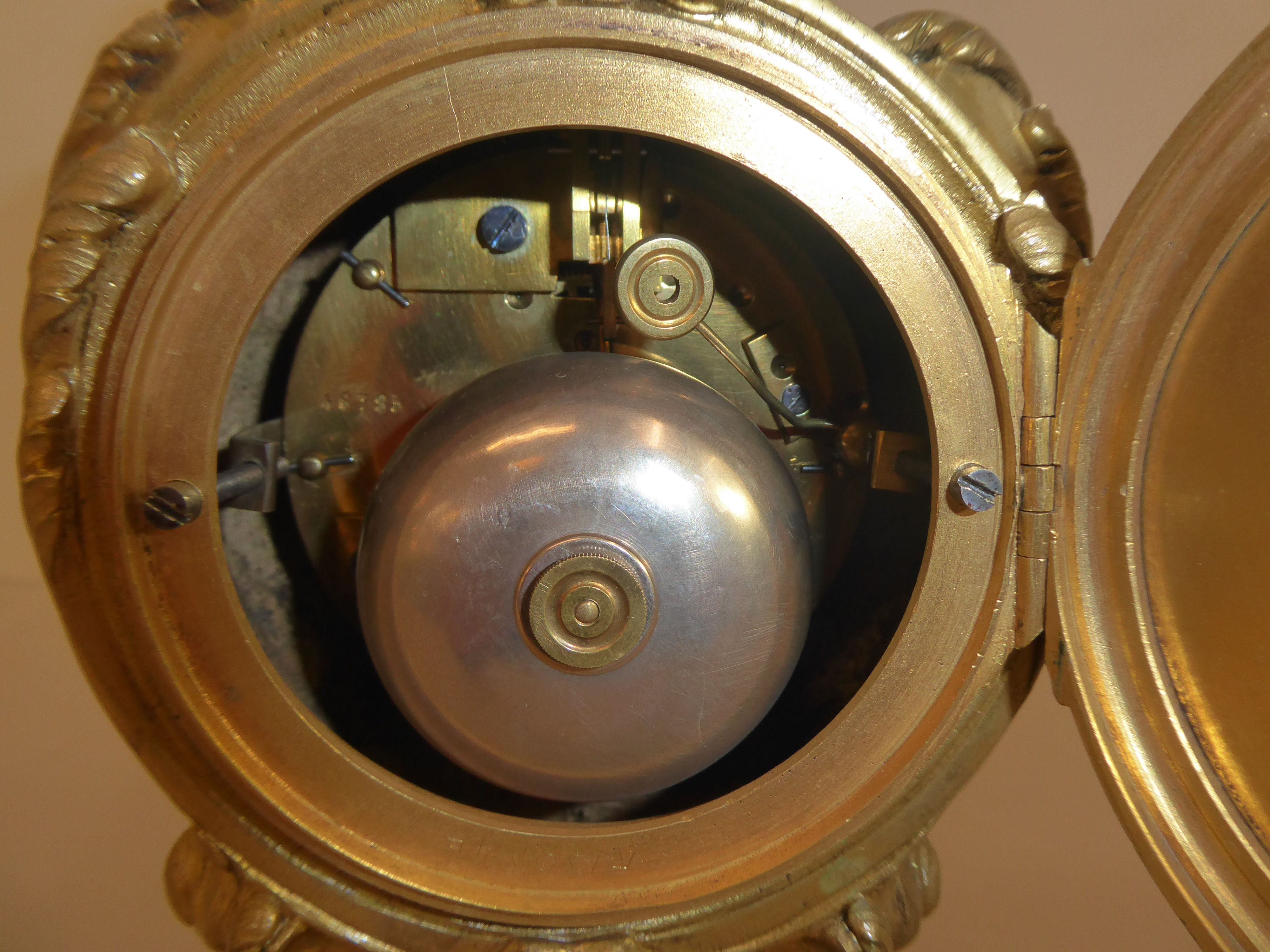 A reproduction of a 19thC gilt metal cased mantel clock of balloon design, surmounted by a pair of - Image 6 of 8