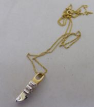 A 9ct bi-coloured gold and three stone diamond set pendant, on a fine neckchain and ring bolt clasp