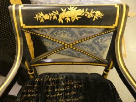 A pair of Regency style black painted and gilt framed elbow chairs with crossover splats and open