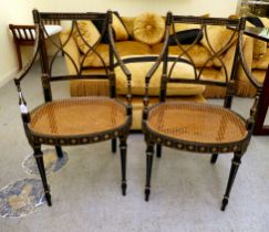 A pair of early 19thC style black painted and gilded beech framed chairs, each having a curved