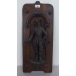 A mid 20thC stained beech wall plaque, surmounted by a spelter musketeer figure  23"h overall