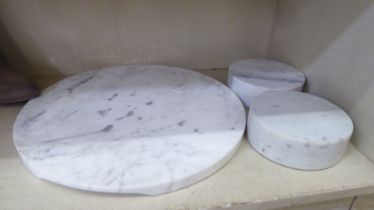 A pair of grey marble plinths  6"dia; and a platter  15"dia