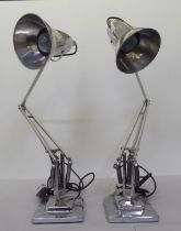 A pair of Angelpoise lamps by Herbert Terry & Sons, in stainless steel, on square bases