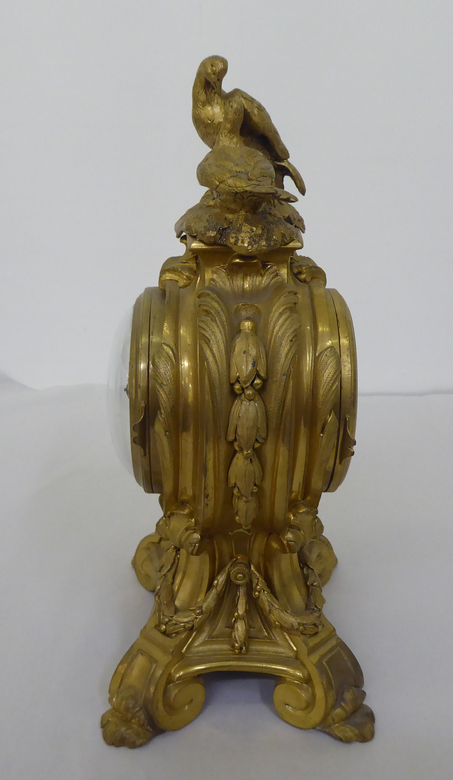 A reproduction of a 19thC gilt metal cased mantel clock of balloon design, surmounted by a pair of - Image 4 of 8