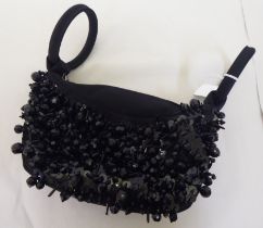 A Lulu Guinness black and bead ornamented handbag with loop handles and dust cover