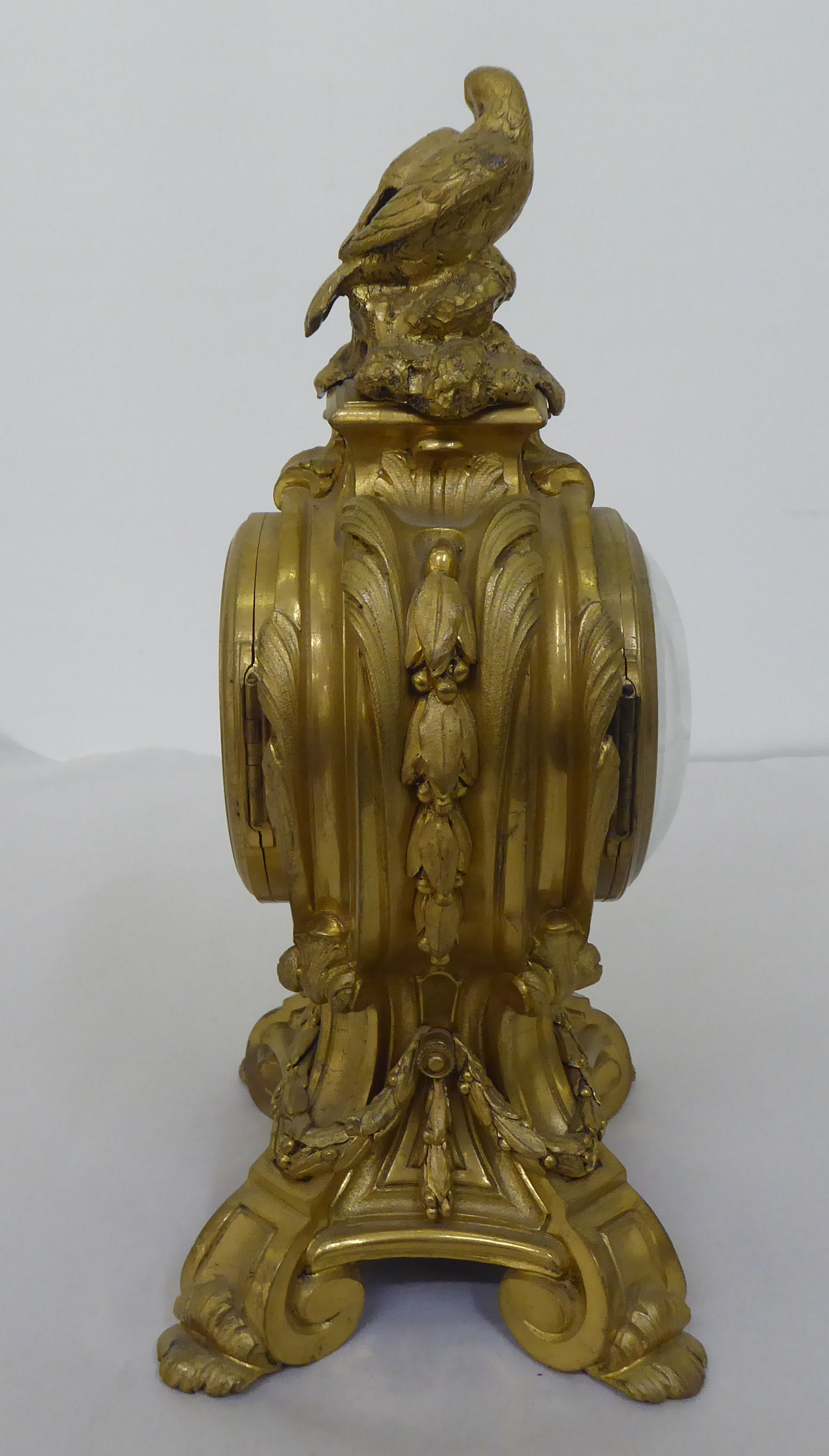 A reproduction of a 19thC gilt metal cased mantel clock of balloon design, surmounted by a pair of - Image 7 of 8