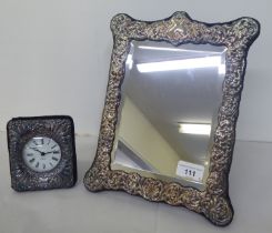 A Victorian style dressing table mirror, the bevelled plate set in an overlaid and embossed silver