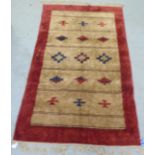A red and brown patterned silk rug  34" x 60"