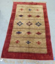 A red and brown patterned silk rug  34" x 60"
