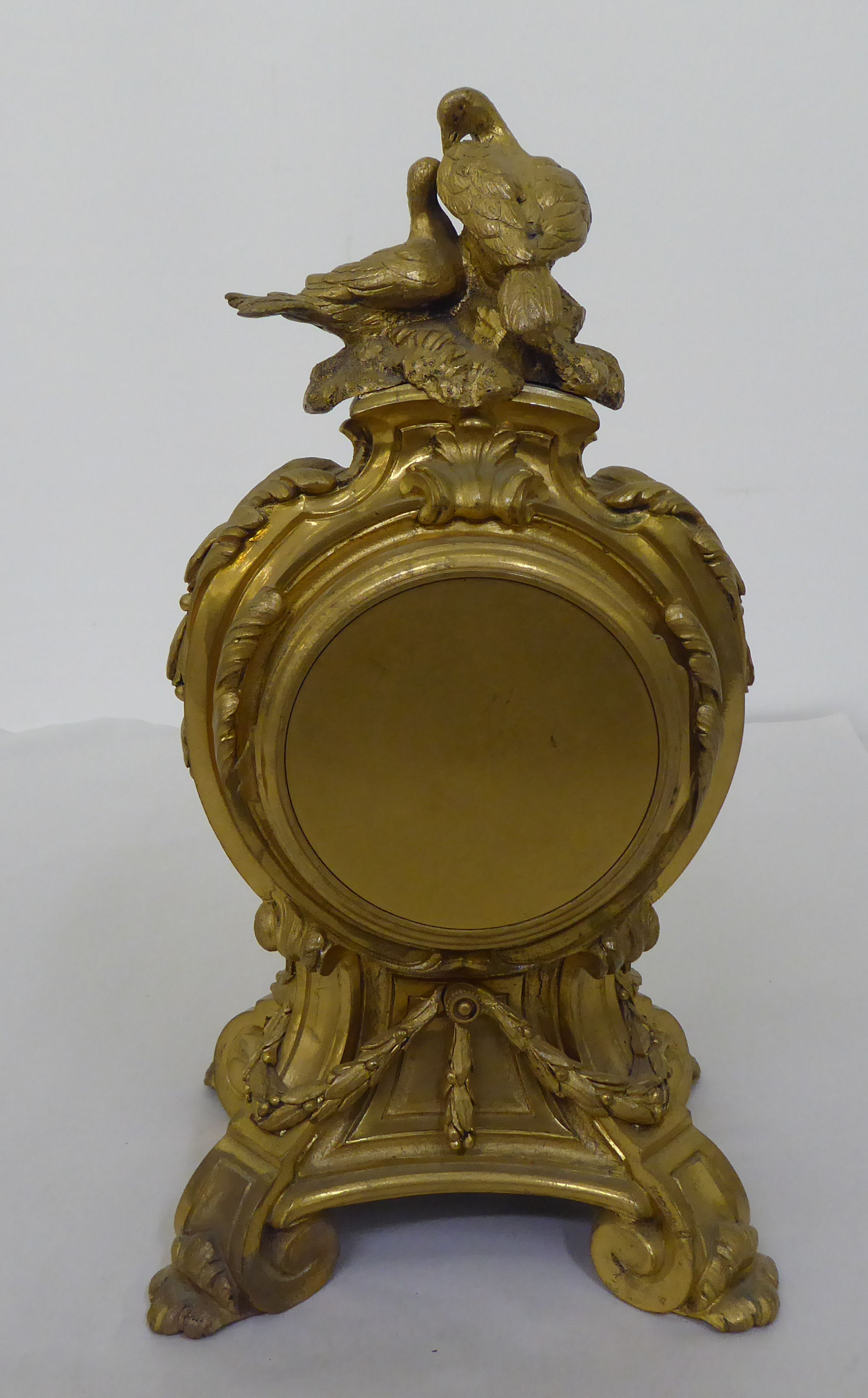 A reproduction of a 19thC gilt metal cased mantel clock of balloon design, surmounted by a pair of - Image 5 of 8