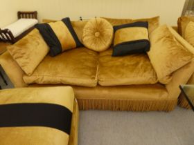 A modern box settee with a low back and enclosed arms, upholstered in tasselled old gold coloured