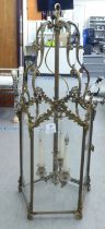 A 19thC style, scrolled gilded metal framed, glazed hexagonal pendant lantern, comprising three