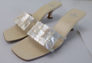 A pair of ladies cream coloured leather and faux mother-of-pearl strapped, low heeled, open toe