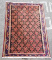 A Persian rug, decorated with geometric motifs, on a dark blue ground  120" x 79"