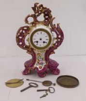 A mid 20thC French mantel timepiece, , set in an ornate Rococo design china and floral overpainted