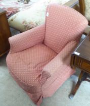 An early 20thC and later fabric covered nursing chair, raised on square, tapered legs and casters