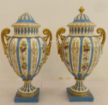 A pair of late 19thC Rudolstadt porcelain vases of urn design, decorated with flowers and fruit