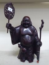 A patinated bronze model, a standing Buddha, holding a staff  15"h