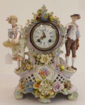 A late 19thC Continental porcelain mantel clock, encrusted with flowers and fruit, surmounted by a