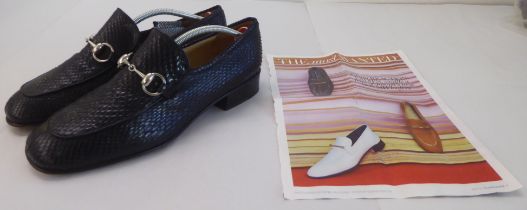 A pair of ladies Gucci snakeskin effect black leather, low heeled, buckled loafers  size 38.5