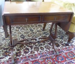 A mid 20thC William IV style mahogany sofa table design occasional table, raised on lyre ends and