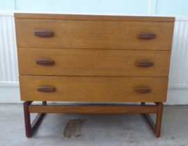 A G-Plan teak dressing chest with three drawers, raised on splayed legs  28"h  32"w