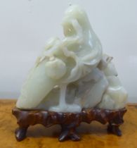 A 20thC carved jade coloured hardstone model, a bird  4"h, on a wooden plinth