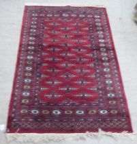 A Persian rug, decorated with geometric motifs, on a red ground  63" x 39"