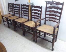 A set of five 20thC Lancashire style, stained beech framed ladderback dining chairs, the rush seats