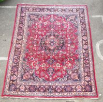 A Persian rung, decorated with floral motifs, on red and blue  138" x 96"