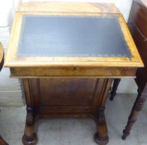 A mid Victorian walnut Davenport with a hinged lid and a bank of four right hand drawers, on a