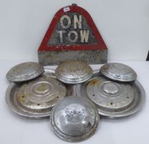 Motor related items, viz. an 'ON Tow' sign  17" x 20"; four Bentley hub caps  10"dia; and two