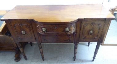 A George III mahogany breakfront sideboard with two central drawers, flanked by two cellarette